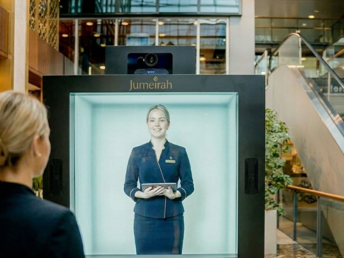 Holographic AI concierge avatar in a hotel lobby